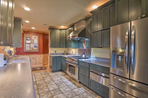 a kitchen with blue cabinets and stainless steel appliances at 22STR-00506 Fairplay Log Cabin 26 Mi to Breck! in Fairplay