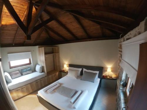 a bedroom with a bed and a couch in a room at Hara's Apartments in Prinos