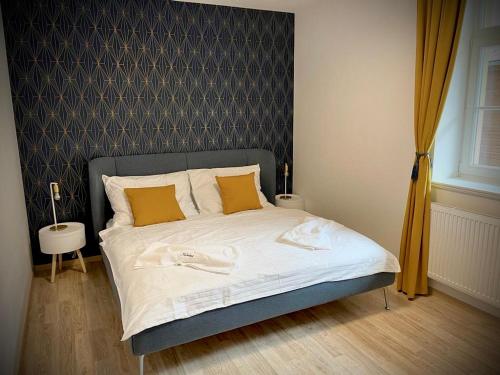 卡爾洛瓦斯圖丹卡的住宿－Apartmán Hubertus No. 17，一间卧室配有带白色床单和黄色枕头的床。