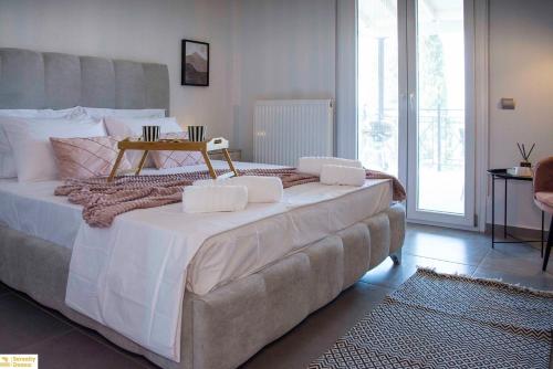 a bedroom with a large bed with a table on it at Serenity Domus in Lefkímmi