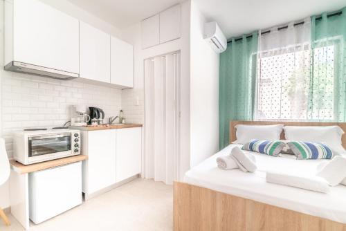 a bedroom with a bed with a microwave on it at Renovated Studio near Downtown in Heraklio
