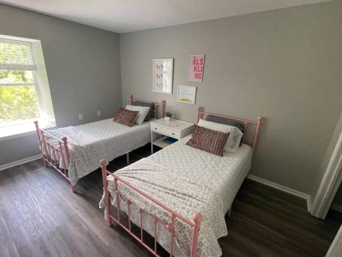a bedroom with two beds and a window at The Ingrid Apt #8 - Fresh and Simple 2bd with WiFi in Hamilton