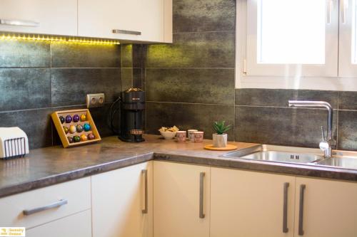 a kitchen with a sink and a counter top at Serenity Domus in Lefkimmi
