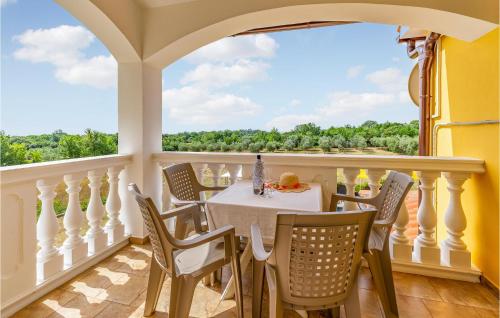 a dining room with a table and chairs on a balcony at Amazing Home In Valtura With House A Panoramic View in Valtura