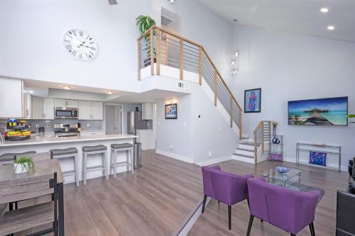 a kitchen and living room with purple chairs and a staircase at Nice Long Stay, Business, Medical Travel, Relocation, Wi-Fi in Tampa