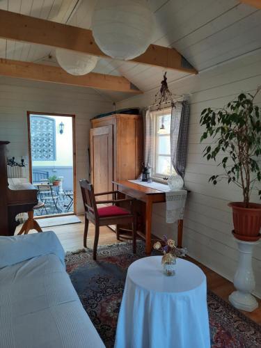 a living room with a table and a desk at Schwedenliebe in Frechen