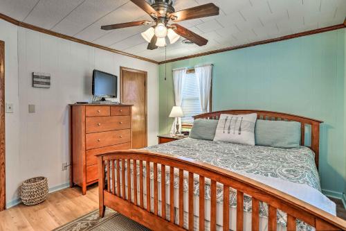 a bedroom with a bed and a ceiling fan at Nags Head Cottage Screened Porch, Walk to Beach! in Nags Head