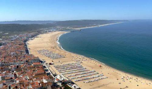 an aerial view of a beach with umbrellas at Lux Life Properties in Nazaré