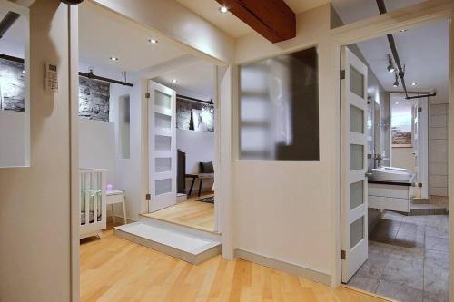 a hallway with a door leading to a bathroom at GENERATIONS QUEBEC OLD CITY/ Parking/ Family in Quebec City