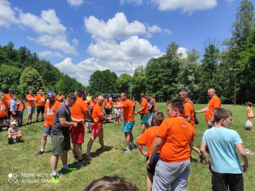 a group of people in orange shirts in a field at Home of nature - kuća prirode in Odžak