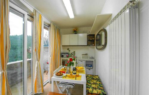 a small kitchen with a table with fruit on it at Cozy Home In Volegno With Kitchenette in Stazzema
