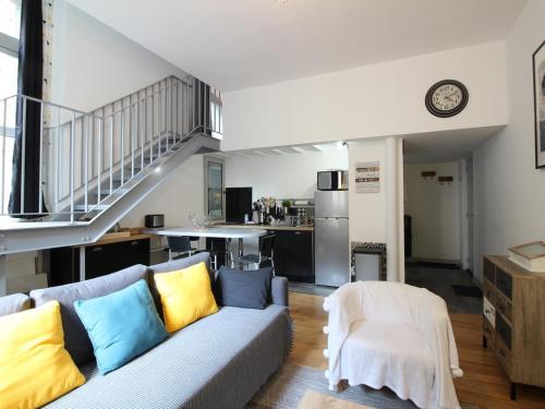 un salon avec un canapé et une cuisine dans l'établissement Bel Appartement T2 Duplex en Hyper Centre, 3*, Parking, 4 Pers., Proche Thermes et Commerces - FR-1-608-233, à La Bourboule