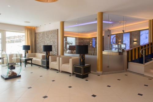 a lobby of a hotel with couches and a table at Hotel Zürserhof in Zürs am Arlberg