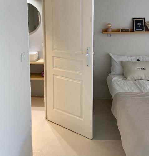 a white door in a bedroom with a bed at NOUS in Agel