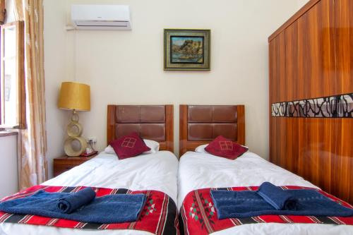 a bedroom with two beds with towels on them at BREAD HOUSE in Bethlehem
