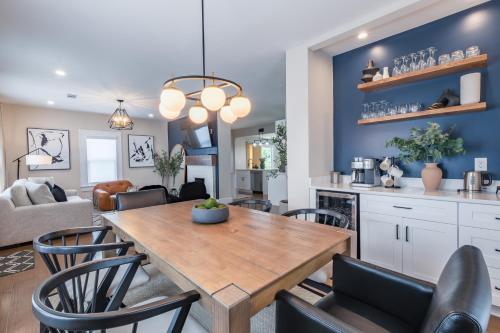 a kitchen and living room with a wooden table and chairs at Blue Haven ATL Modern 4 Bedroom Retreat with Deck 10 Minutes to Downtown in Atlanta