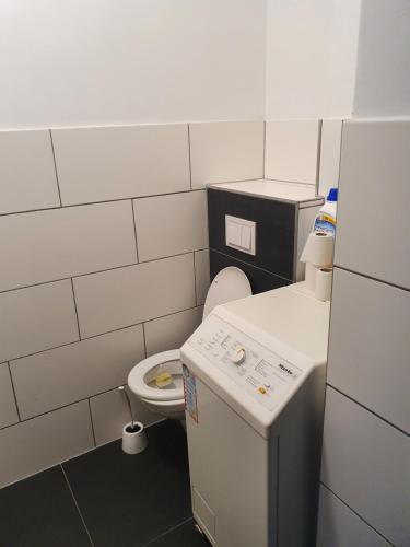 a small bathroom with a toilet and a sink at Apartment RITHEL in Vienna