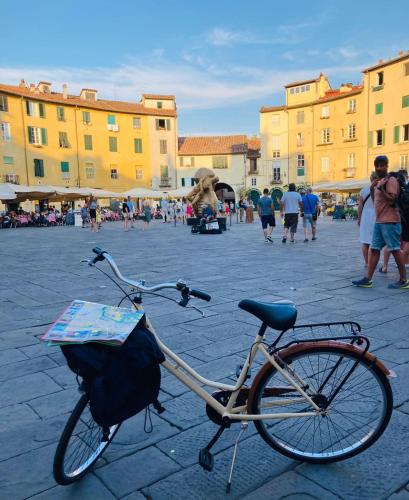 a bike parked in a square in a city at BnB Villa Melany vicino Centro in Lucca