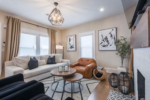 a living room with a couch and a table at Blue Haven ATL Modern 4 Bedroom Retreat with Deck 10 Minutes to Downtown in Atlanta