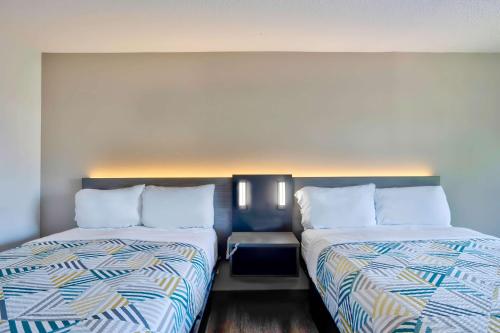 two beds sitting next to each other in a room at Motel 6 Virginia Beach in Virginia Beach