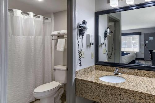 a bathroom with a toilet and a sink and a mirror at Best Western Allatoona Inn & Suites in Cartersville