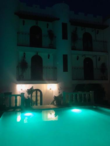 a dark room with a swimming pool at night at Castillo De La Santa Cruz in Guanajuato