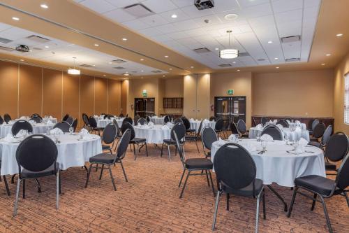 a banquet hall with white tables and chairs at Best Western Plus, Bathurst Hotel & Suites in Bathurst