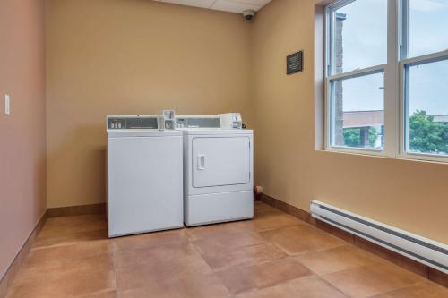 a washer and dryer in a room with a window at Best Western Plus, Bathurst Hotel & Suites in Bathurst