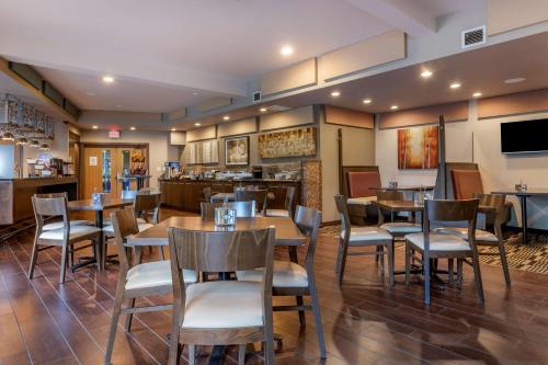 a restaurant with tables and chairs and a bar at Best Western Plus Bridgewater Hotel & Convention Centre in Bridgewater