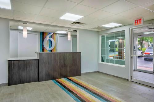 a lobby with a waiting room with a exit at Motel 6 Tulsa, Ok - Central in Tulsa