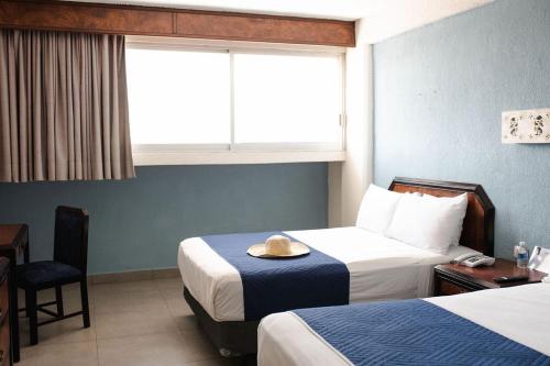 Ένα ή περισσότερα κρεβάτια σε δωμάτιο στο Hotel Los Aluxes