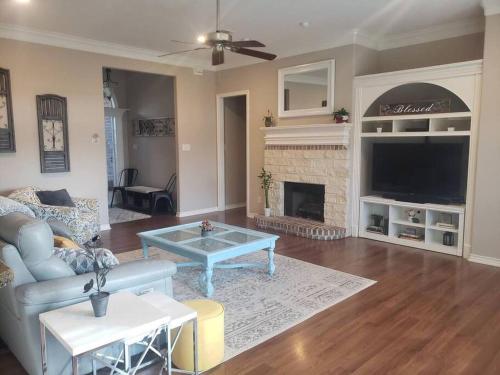 a living room with a couch and a fireplace at Century Tree Lodge - Family & Football Friendly in College Station