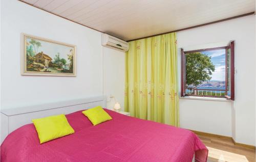 a bedroom with a pink bed and a window at Amazing Home In Jablanac With 2 Bedrooms And Outdoor Swimming Pool in Jablanac