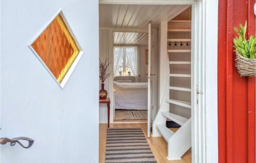 a hallway with a door leading to a room with a bed at 2 Bedroom Gorgeous Home In Åsa in Åsa