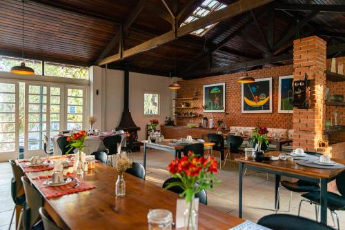 a restaurant with tables and chairs in a room at Pousada Recanto das Rosas in Bragança Paulista