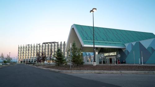 a building with a green roof next to a street at Grey Eagle Resort in Calgary