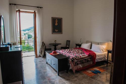a bedroom with a bed and a large window at Narni Charm in Narni