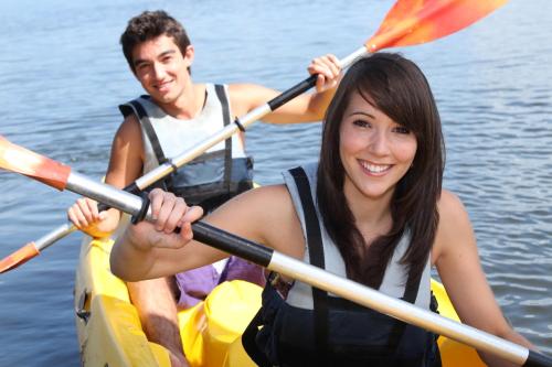 a man and a woman in a kayak on the water at Maqai Beach Eco Resort in Qamea