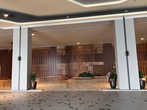 a lobby with tables and chairs in a building at Dsistyle Islamic House in Kuala Lumpur