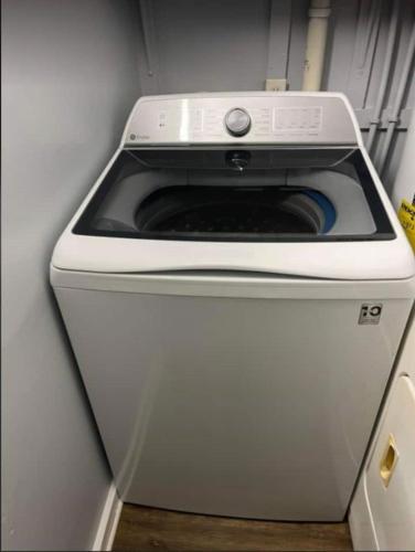 a washer and dryer sitting in a refrigerator at 3 Bed 3 Bath House, Conveniently close to everything, Smart Tvs in all rooms whole house to yourself in New Bern