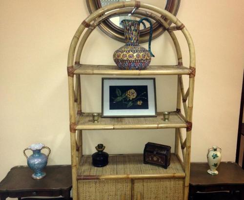 a shelf with vases and a picture on it at Star Hostel San Siro Fiera in Milan