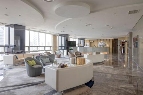 a living room with couches and chairs in a building at Holiday Inn Incheon Songdo by IHG in Incheon