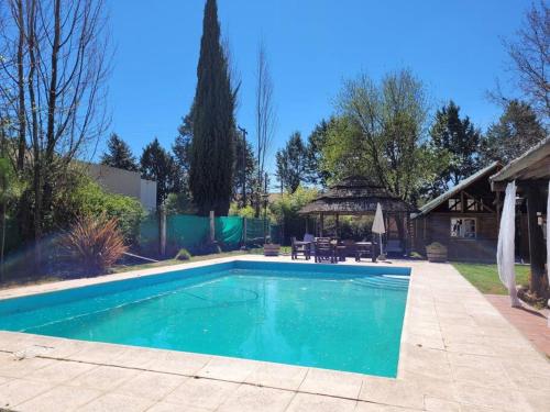 a swimming pool in the backyard of a house at ENTRE VIÑAS in Ciudad Lujan de Cuyo