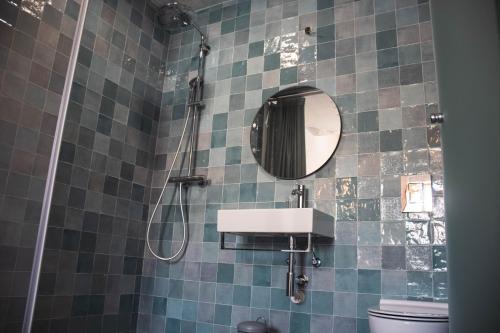 a bathroom with a sink and a mirror at Laurus - Charming House in Raposeira