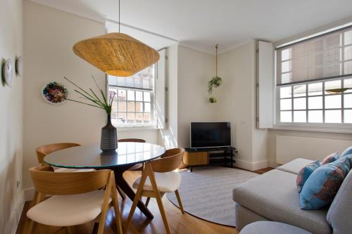 a living room with a table and chairs and a couch at BOUTIQUE Rentals- DOURO Ribeira historical center with parking in Porto