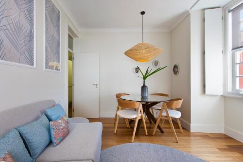 a living room with a table and a couch at BOUTIQUE Rentals- DOURO Ribeira historical center with parking in Porto