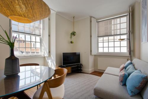 a living room with a table and a couch at BOUTIQUE Rentals- DOURO Ribeira historical center with parking in Porto