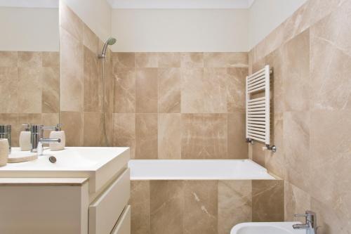 a bathroom with a tub and a sink and a toilet at BOUTIQUE Rentals- DOURO Ribeira historical center with parking in Porto