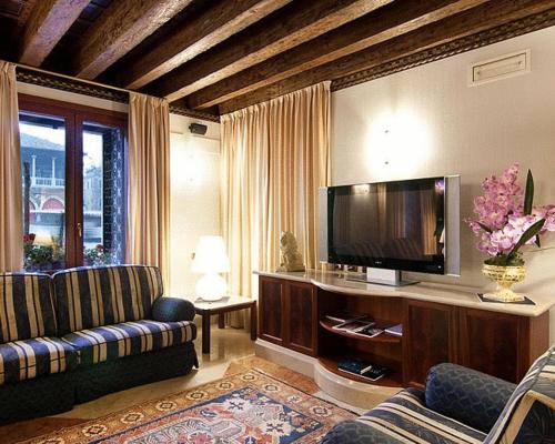 a living room with a couch and a flat screen tv at Foscari Palace in Venice