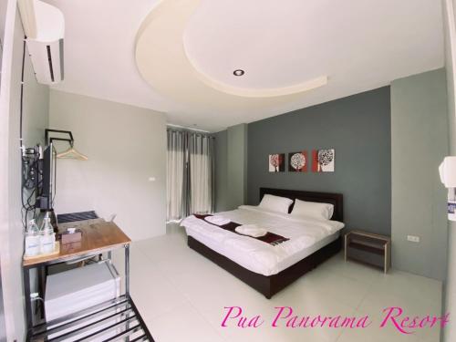 a bedroom with a bed and a desk in it at Pua Panorama Resort in Nan